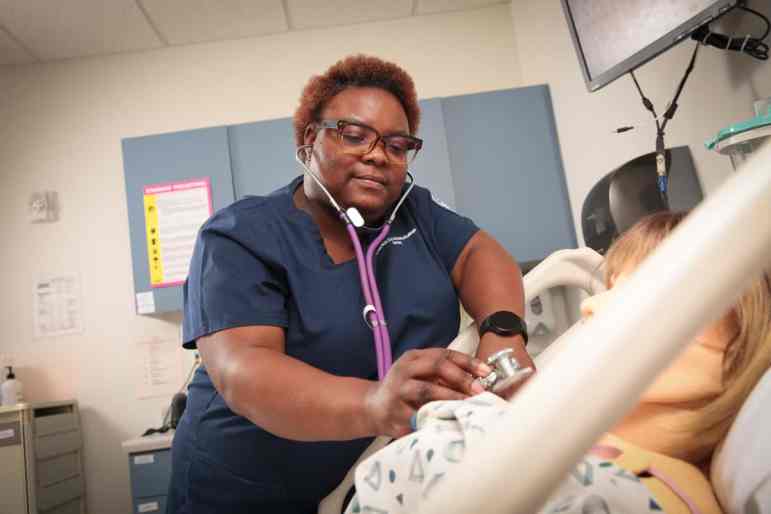 A nursing student works in a simulation lab at Milwaukee Area Technical College. Health care careers such as certified nursing assistant are among the top jobs of MATC graduates.