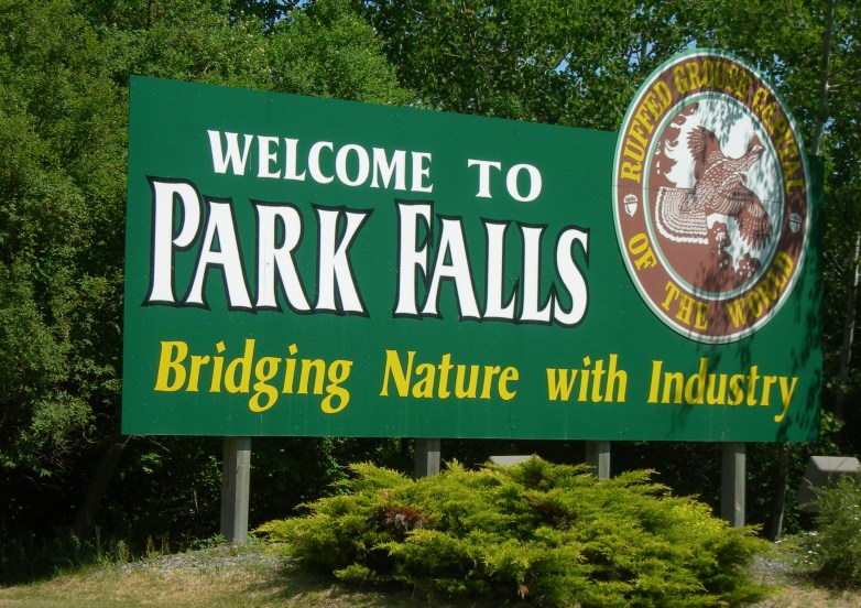 A billboard that says "Welcome to Park Falls."