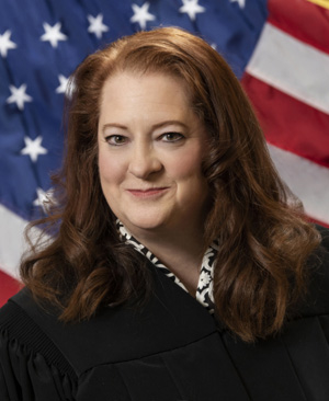 2nd District Court of Appeals Judge Maria Lazar in front of an American flag