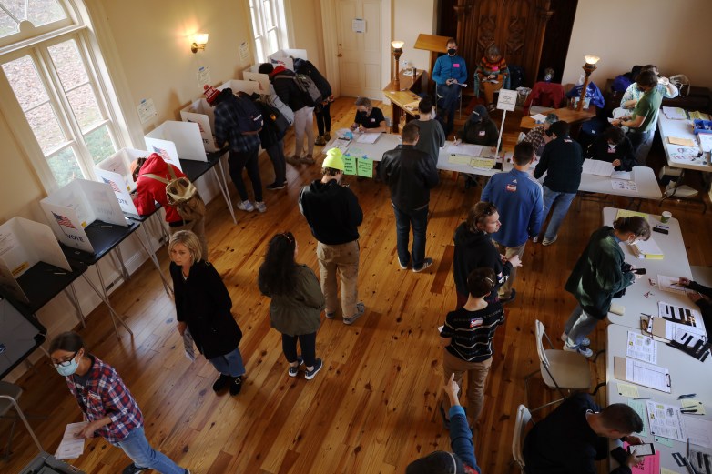 An overhead view shows people in line to vote.