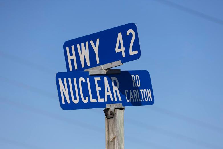 Blue “HWY 42” and “NUCLEAR RD CARLTON” signs