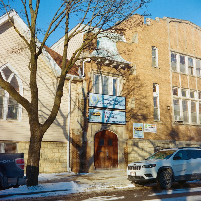 A brick building with signs reading 