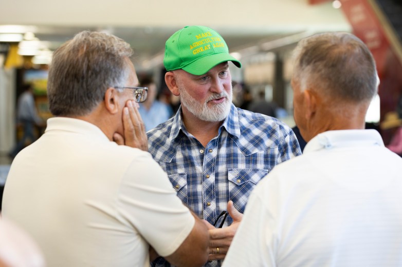 A person wearing a green hat reading